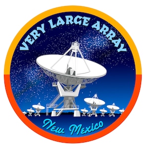 May include: A circular patch with a blue background and white stars. The text "VERY LARGE ARRAY" is written in a white arc around the top of the patch. The text "New Mexico" is written in a blue arc at the bottom of the patch. The patch features a large white satellite dish with smaller satellite dishes in the background.