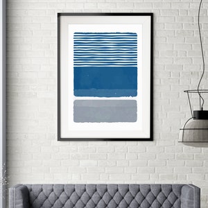 May include: Abstract art print with a blue and gray color scheme. The print features a series of horizontal stripes in blue and white, followed by a solid blue rectangle and a solid gray rectangle.