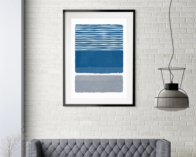 May include: Abstract art print with a blue and gray color scheme. The print features a series of horizontal stripes in blue and white, followed by a solid blue rectangle and a solid gray rectangle.
