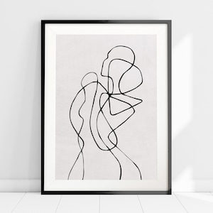 May include: Black and white abstract line art print in a black frame. The print features a series of curved lines that create a flowing, organic design.