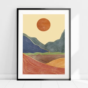 May include: Abstract art print featuring a stylized landscape with a large orange sun, blue and green mountains, and gold lines. The background is a light yellow.
