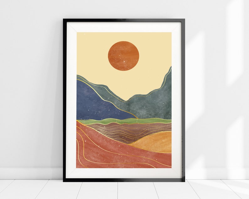May include: Abstract art print featuring a stylized landscape with a large orange sun, blue and green mountains, and gold lines. The background is a light yellow.