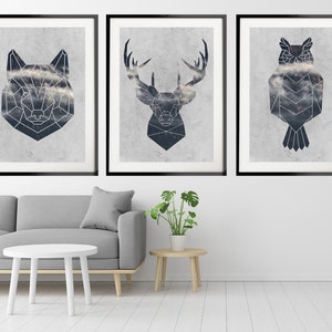 May include: Three framed prints with geometric animal illustrations. The prints feature a wolf, a deer, and an owl. Each animal is depicted in a black and white geometric style, with a cloudy background.