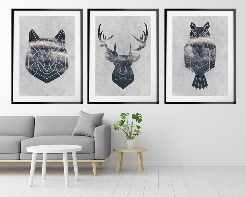 May include: Three framed prints with geometric animal illustrations. The prints feature a wolf, a deer, and an owl. Each animal is depicted in a black and white geometric style, with a cloudy background.