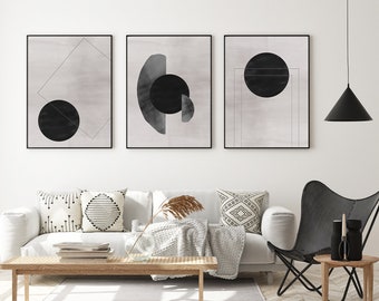 May include: Three black and white abstract art prints with geometric shapes and circles. The prints are framed in black and hung on a white wall.