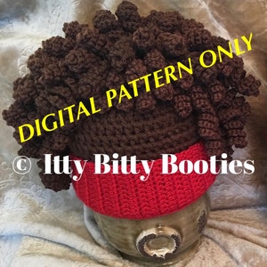May include: Crochet pattern for a brown and red beanie hat with a curly brown hair top. The pattern is called "Itty Bitty Booties" and is available as a digital download only.
