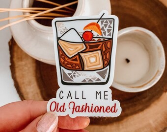 May include: A white sticker with a cartoon illustration of an old fashioned cocktail with a cherry and orange slice. The text "CALL ME Old Fashioned" is written below the illustration.