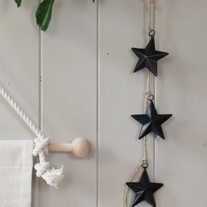 Black metal 3D stars with hanging loop. They measure 6cm from point to point.
Perfect for a hanging decoration or added to your gifts.