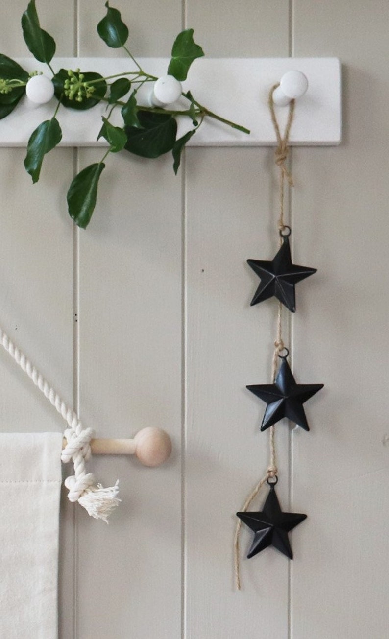 Black metal 3D stars with hanging loop. They measure 6cm from point to point.
Perfect for a hanging decoration or added to your gifts.