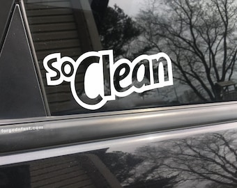 May include: White vinyl decal with the words "So Clean" in a bold, stylized font. The decal is applied to a black car window.
