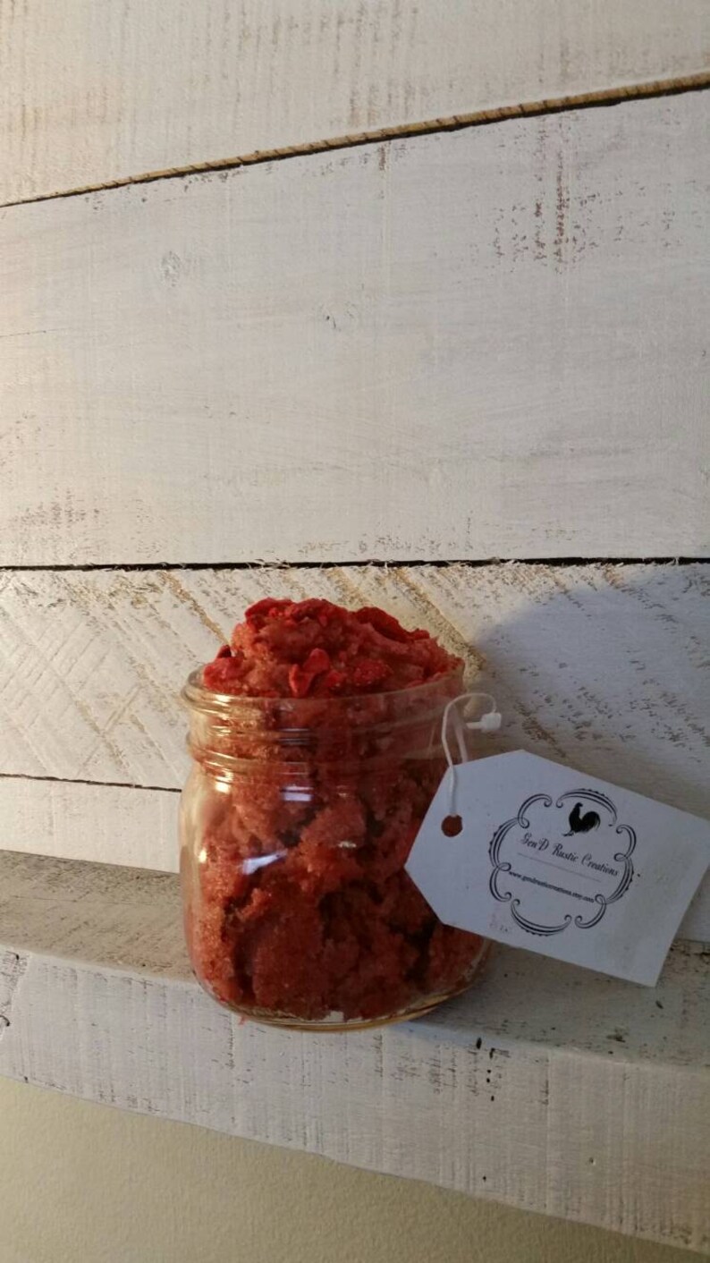 May include: A glass jar filled with red sugar scrub, labelled "Jen P Rustic Creations".