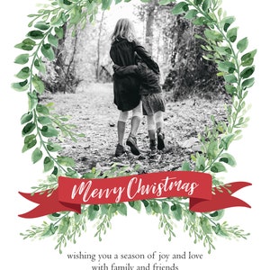 May include: A Christmas card with a black and white photo of two girls walking in a forest. The photo is framed by a green wreath with a red ribbon that says "Merry Christmas". The card also includes the text "wishing you a season of joy and love with family and friends" and "Tom, Beth, Amy, and Lila Peterson - 2018 -."
