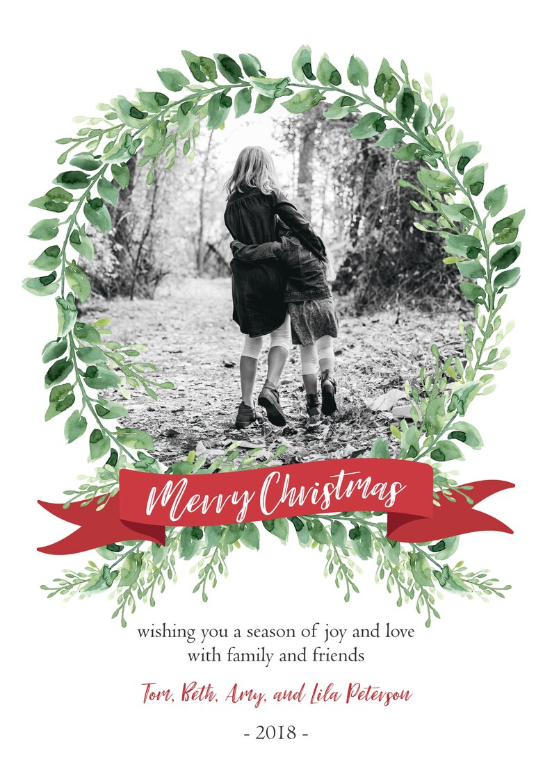 May include: A Christmas card with a black and white photo of two girls walking in a forest. The photo is framed by a green wreath with a red ribbon that says "Merry Christmas". The card also includes the text "wishing you a season of joy and love with family and friends" and "Tom, Beth, Amy, and Lila Peterson - 2018 -."