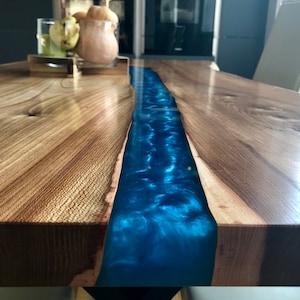 Live Edge Dining Blue River Table made in a modern rustic finish with black steel legs and Blue epoxy resin river