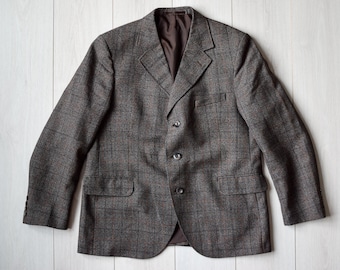 May include: A brown plaid blazer with three buttons and a brown lining.
