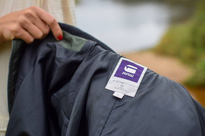 May include: A black jacket with a purple G-Star RAW label. The label says "G-Star RAW" and "Made in China".