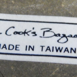 May include: White label with black text that reads "The Cook's Bazaar" and "Made in Taiwan".