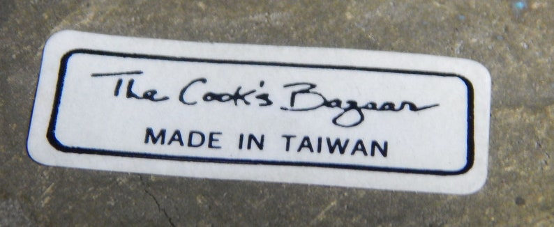 May include: White label with black text that reads "The Cook's Bazaar" and "Made in Taiwan".