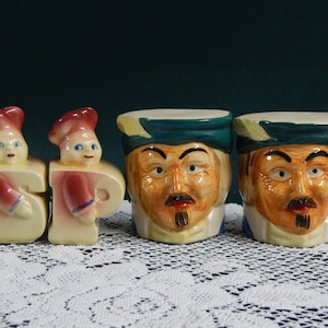 May include: Set of four vintage ceramic salt and pepper shakers. Two shakers are shaped like the letters "S" and "P" with a chef design. The other two shakers are shaped like faces with green hats.