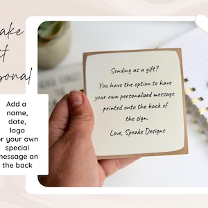May include: A square wooden sign with a cream-coloured front featuring black text that reads: Sending as a gift? You have the option to have your own personalised message printed onto the back of the sign. Love, Speake Designs.