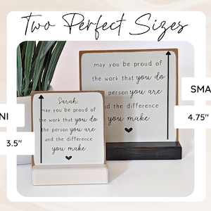May include: Two wooden signs with black text reading: Sarah, may you be proud of the work that you do, the person you are and the difference you make. The mini sign is 8.89 cm tall, and the small sign is 12.07 cm tall, both with hearts.