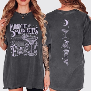May include: Dark grey t-shirt with a front graphic that says "Midnight Margaritas" with a cocktail illustration. The back of the shirt has a series of cocktail-themed illustrations. The shirt is a relaxed fit.