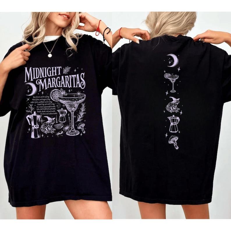 May include: Black t-shirt with the text "Midnight Margaritas" and a cocktail graphic on the front. The back of the shirt features a series of cocktail-themed illustrations. The shirt is a casual, oversized fit.