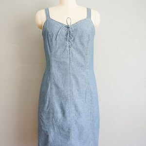 May include: A light blue denim dress with a lace-up detail at the bodice.