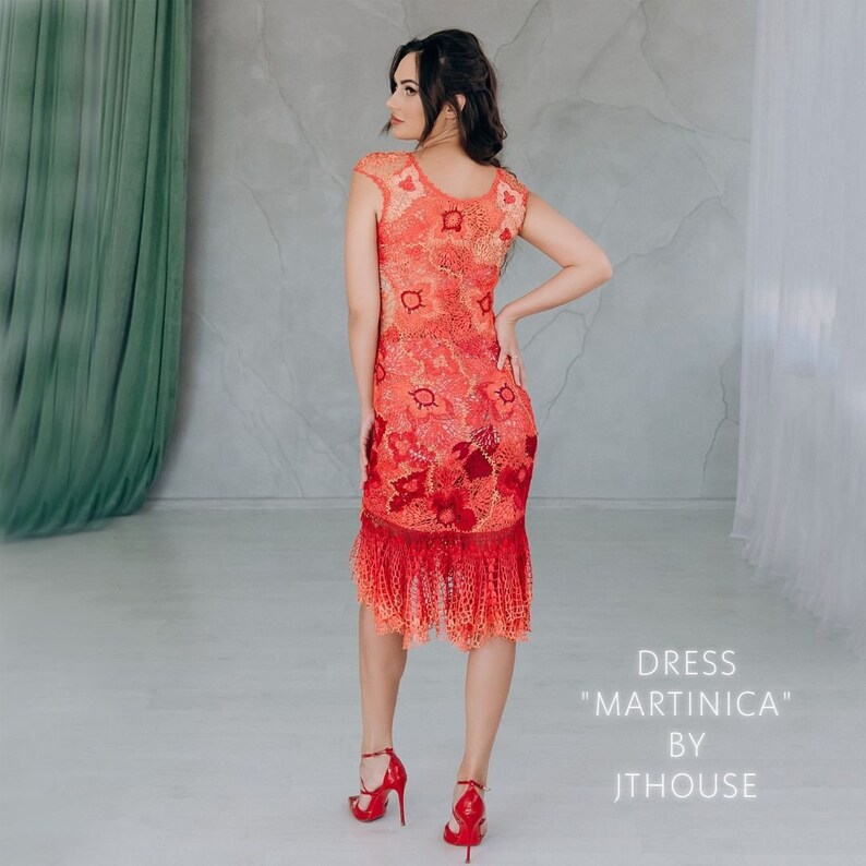 May include: A red and orange crochet dress with a scalloped hem and fringe. The dress is fitted and has a scoop neck. The dress is called "Martinica" by Jthouse.