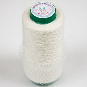 May include: A white spool of yarn with a green and white label that says "jthouse.net" and "jthouse".
