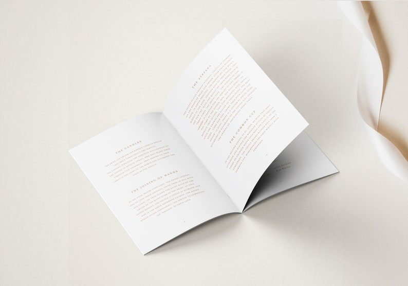 May include: An open book with white pages and gold text. The text on the left page reads "The Candle" and "The Joining of Hands". The text on the right page reads "The Readings" and "The Common Cup".