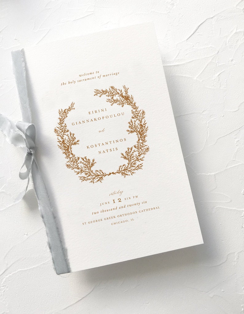May include: A wedding invitation with a gold floral wreath and the names "Eirini Giannakopoulou" and "Konstantinos Natsis". The invitation is for June 12th, 2026 at 6 PM at St. George Greek Orthodox Cathedral in Chicago, IL.