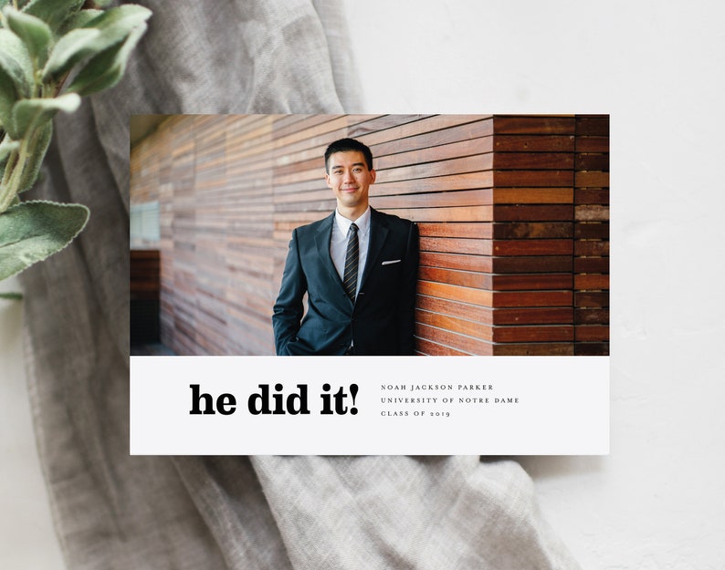 May include: A graduation announcement card with a photo of a man in a suit and tie. The text on the card reads "he did it!"  Noah Jackson Parker, University of Notre Dame, Class of 2019.