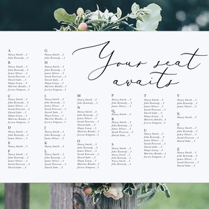 May include: A white seating chart with black text lists names and table assignments for a wedding reception. The text "Your seat awaits" is written in cursive at the top of the chart.