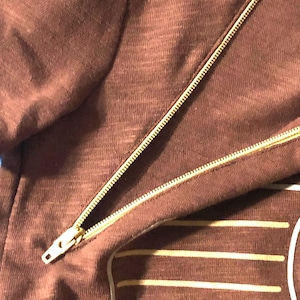 May include: A set of three ceramic mugs with a speckled, matte finish in cream, light blue, and gray. Each mug has a rounded handle and a simple, modern design, perfect for coffee or tea.