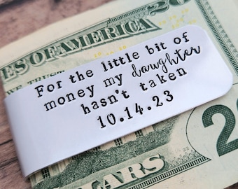 May include: Silver money clip with the engraved text "For the little bit of money my daughter hasn't taken 10.14.23".