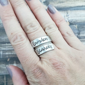 May include: Two silver rings with the names "Camden" and "Blakely" engraved on them.