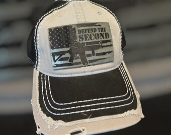 May include: A distressed, gray and black baseball cap with a patch featuring an American flag and the text "Defend the Second".