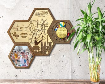 May include: Wooden, hexagonal wall art piece with a map of Tokyo, a marathon medal, and a photo. The map is etched into the wood, with the text "Tokyo Marathon 2026". The medal is gold with colorful ribbons. The photo shows a marathon runner.