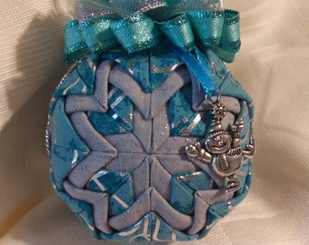 Silver and Teal fabrics folded star ball ornament with a jolly snowman charm.