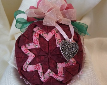 Pink and Cranberry fabrics folded star quilt design ball ornament with a MOM heart charm.