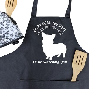 May include: Black apron with a white silhouette of a corgi and the text "Every meal you make every bite you take I'll be watching you."