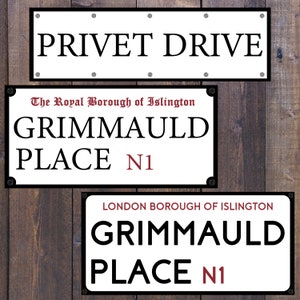 May include: Three white street signs with black lettering. The top sign reads "PRIVET DRIVE". The middle sign reads "The Royal Borough of Islington GRIMMAULD PLACE N1". The bottom sign reads "LONDON BOROUGH OF ISLINGTON GRIMMAULD PLACE N1".