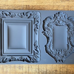 May include: A grey silicone mould with two ornate frame designs. The mould is labelled "Frames IOD" and includes measurements in inches.