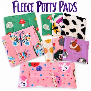 May include: A collection of square and rectangular fleece potty pads featuring various colorful prints including butterflies, mushrooms, cow spots, frogs, and guinea pigs. The text FLEECE POTTY PADS is displayed in purple at the top of the image.