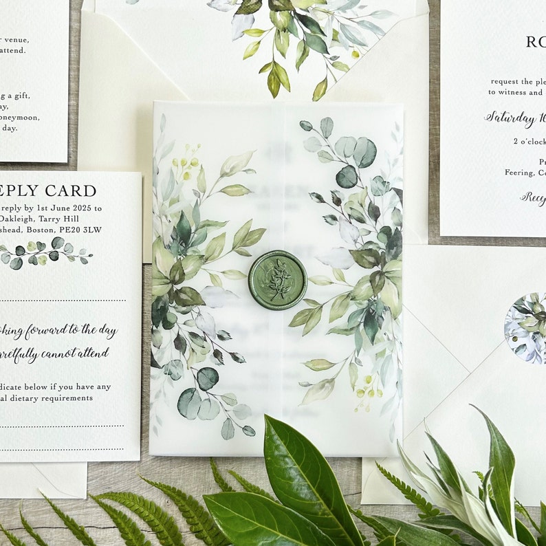 A botanical wedding invitation printed on quality 350gsm ivory cardstock The invite is wrapped in a greenery printed 150gsm vellum jacket. Finished & sealed with a luxury wax seal.