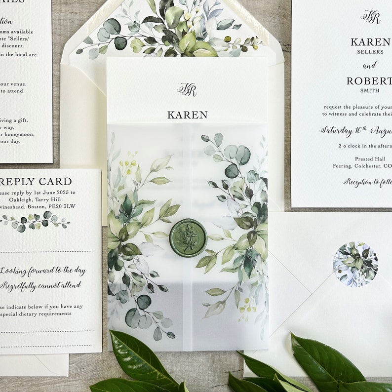 A botanical wedding invitation printed on quality 350gsm ivory cardstock The invite is wrapped in a greenery printed 150gsm vellum jacket. Finished & sealed with a luxury wax seal.