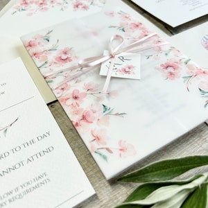 Pink cherry blossom wedding invitation with vellum wrap