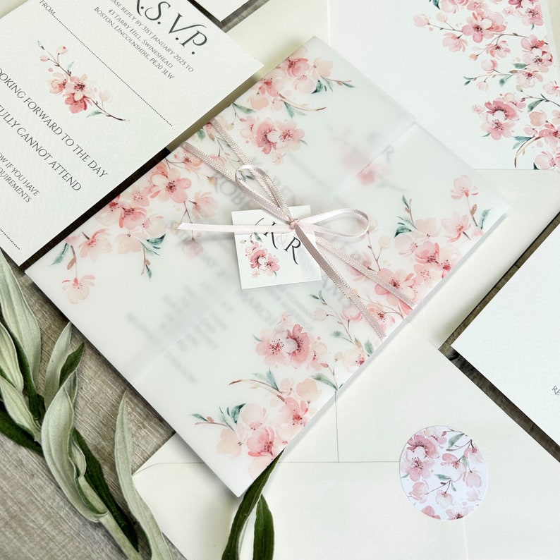 pink floral wedding invitation with printed cherry blossom on vellum jacket