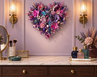May include: A heart-shaped wall decoration composed of various artificial flowers and succulents in shades of purple, pink, and blue. The arrangement features diverse floral textures, including small sprigs, larger blooms, and leafy green elements.